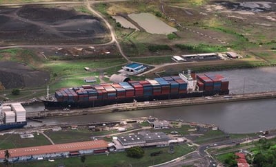 Cargo ship travels through the Panama Canal.